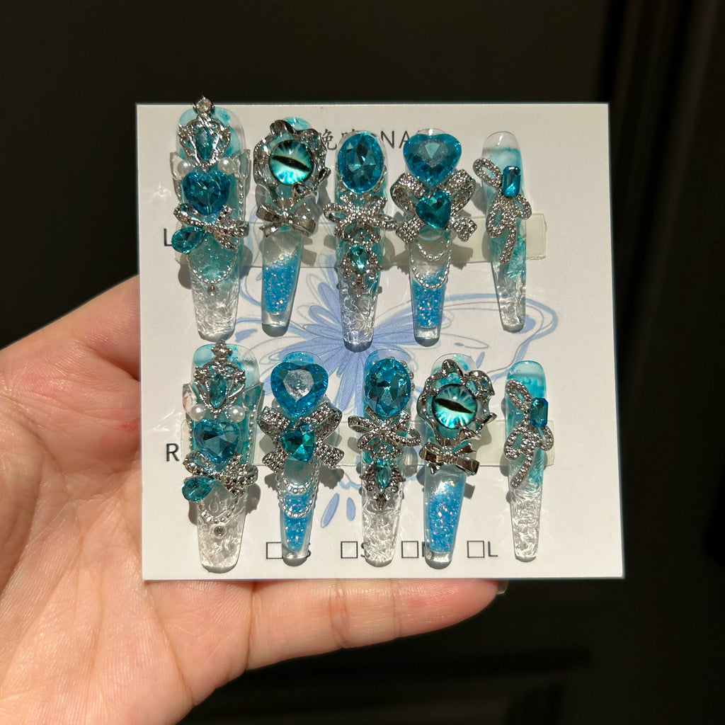 Handmade press-on nails: blue quicksand, elegant, luxurious, heavily detailed, whitening, and seductive