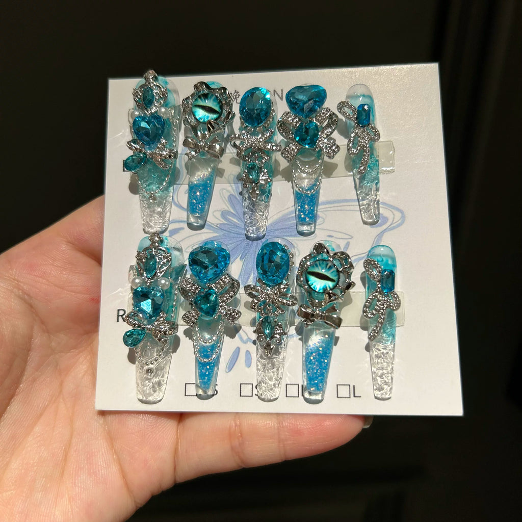 Handmade press-on nails: blue quicksand, elegant, luxurious, heavily detailed, whitening, and seductive