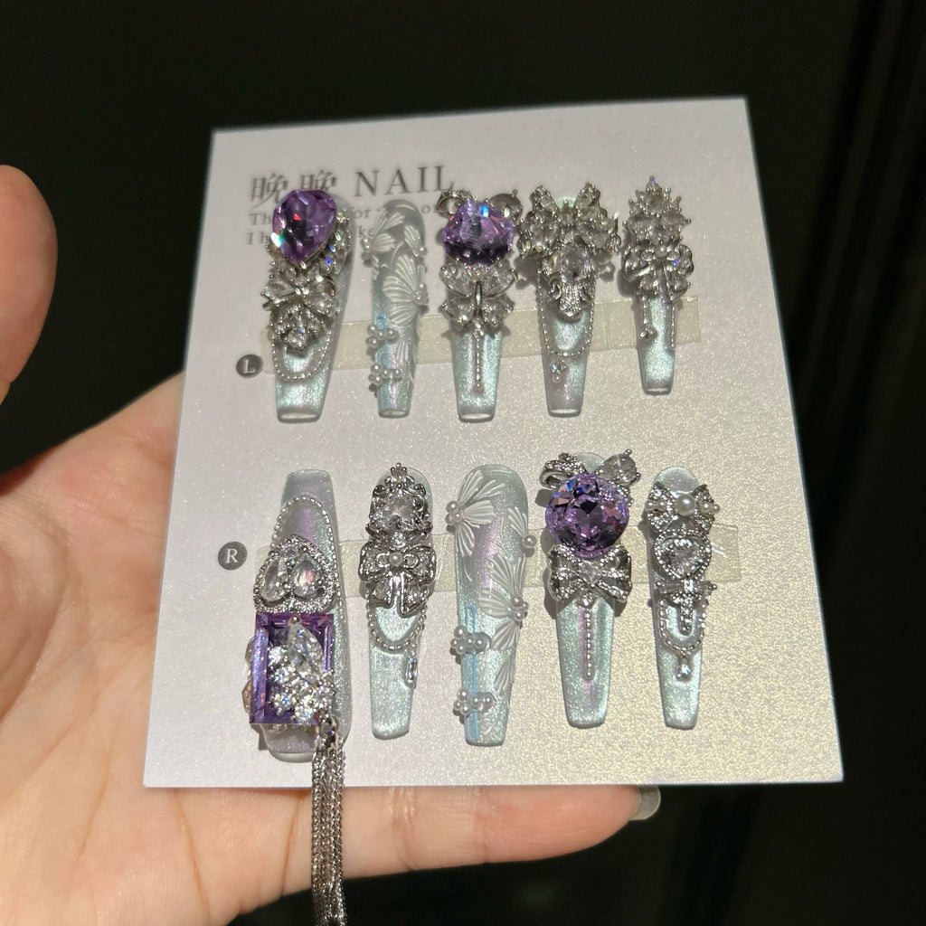 Hand-painted, long press-on nails featuring embroidery-style designs, color-blocking, and a cat-eye effect—entirely handmade.