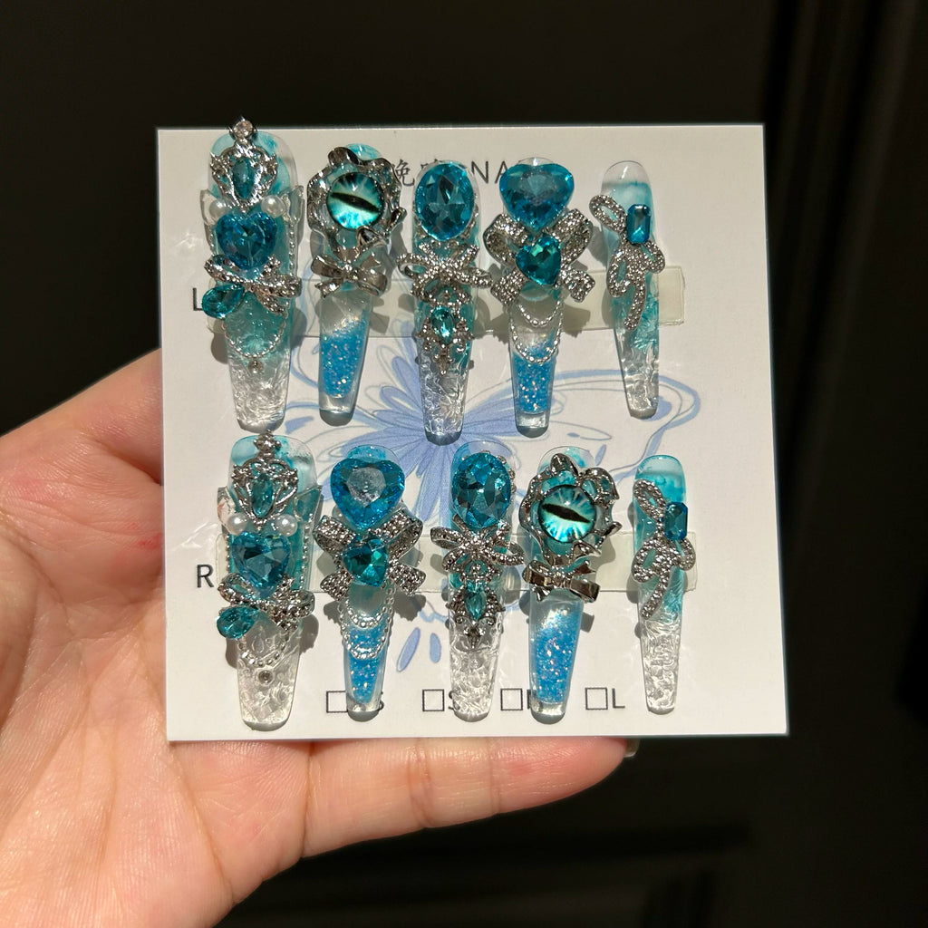 Handmade press-on nails: blue quicksand, elegant, luxurious, heavily detailed, whitening, and seductive