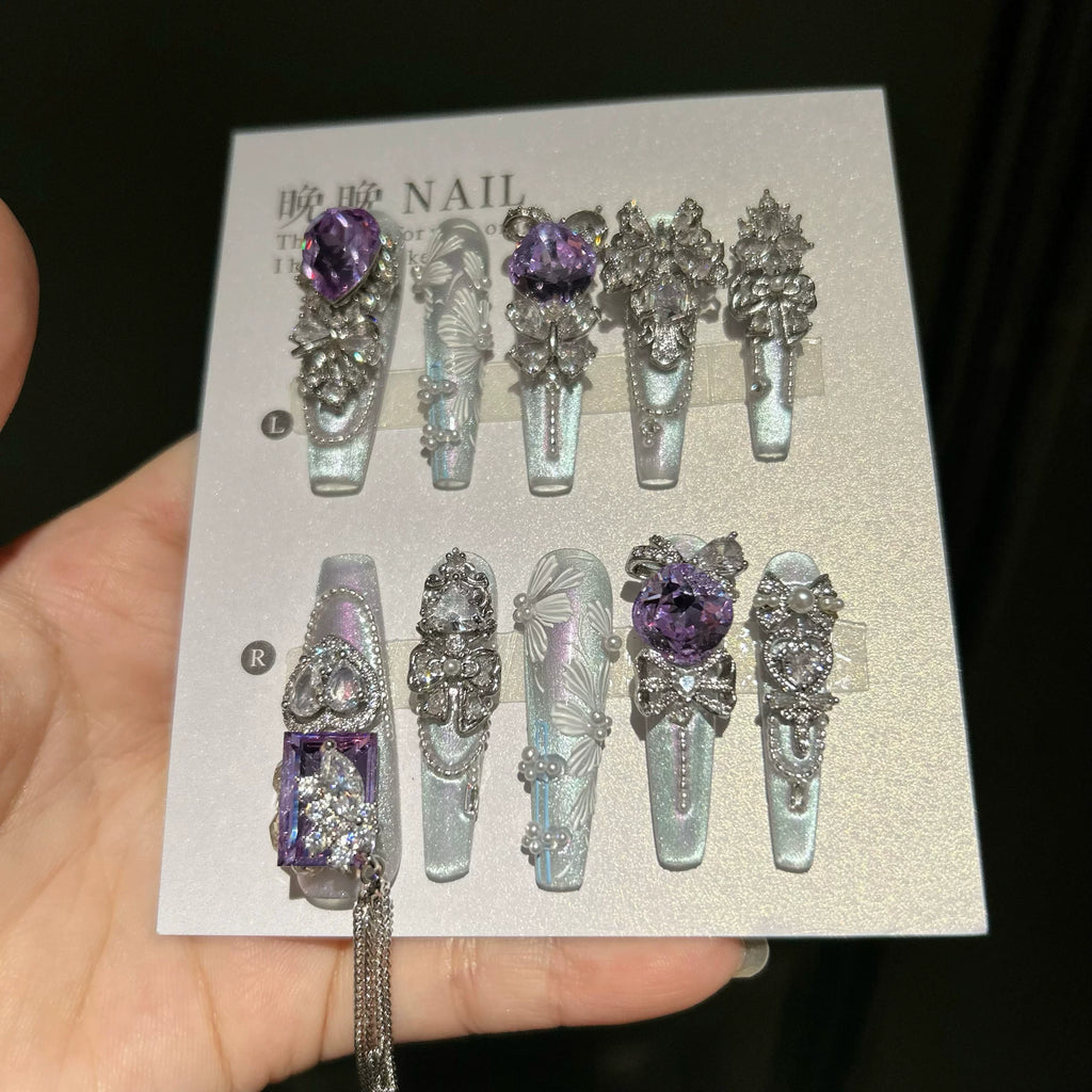 Hand-painted, long press-on nails featuring embroidery-style designs, color-blocking, and a cat-eye effect—entirely handmade.