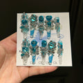 Handmade press-on nails: blue quicksand, elegant, luxurious, heavily detailed, whitening, and seductive