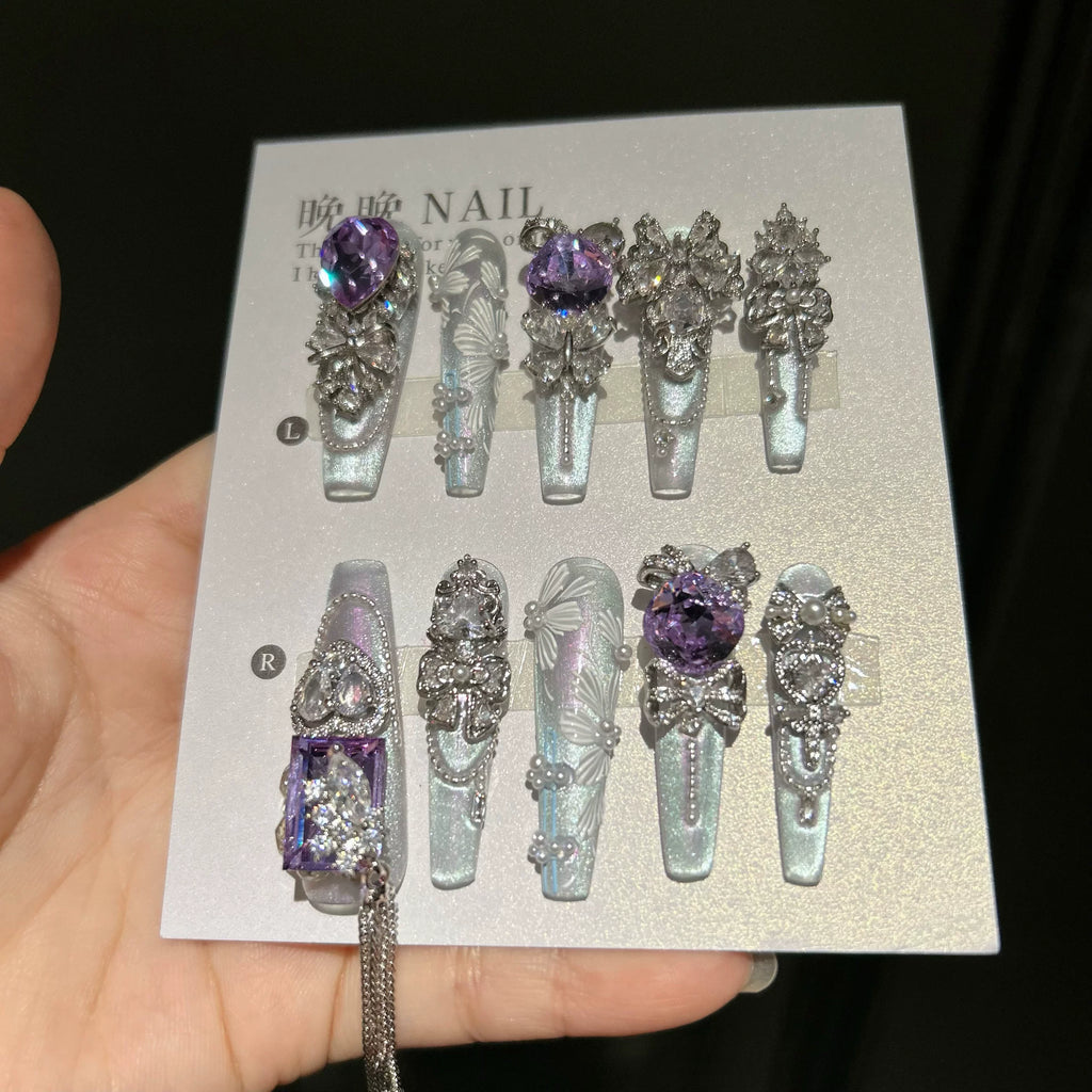 Hand-painted, long press-on nails featuring embroidery-style designs, color-blocking, and a cat-eye effect—entirely handmade.